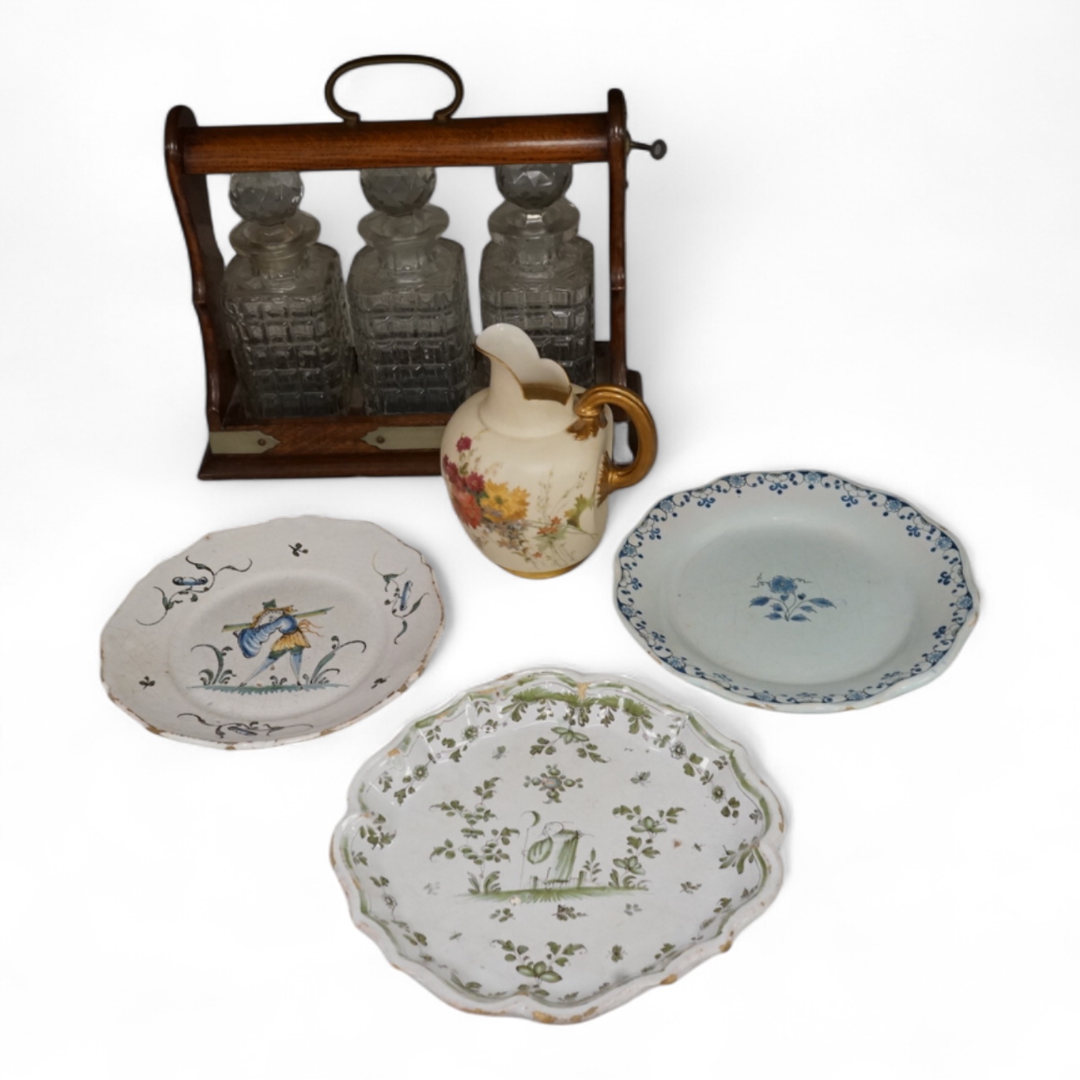 An oak three bottle tantalus, with key, together with three 18th/19th century faience plates and a Royal Worcester jug, tantalus 36cm wide